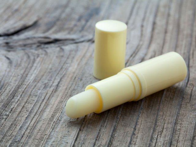 71345741 - lip balm on old wood background